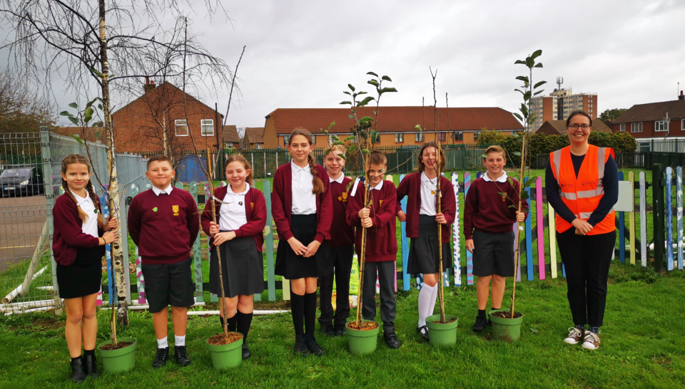 Pupils, trees and Veolia staff member 